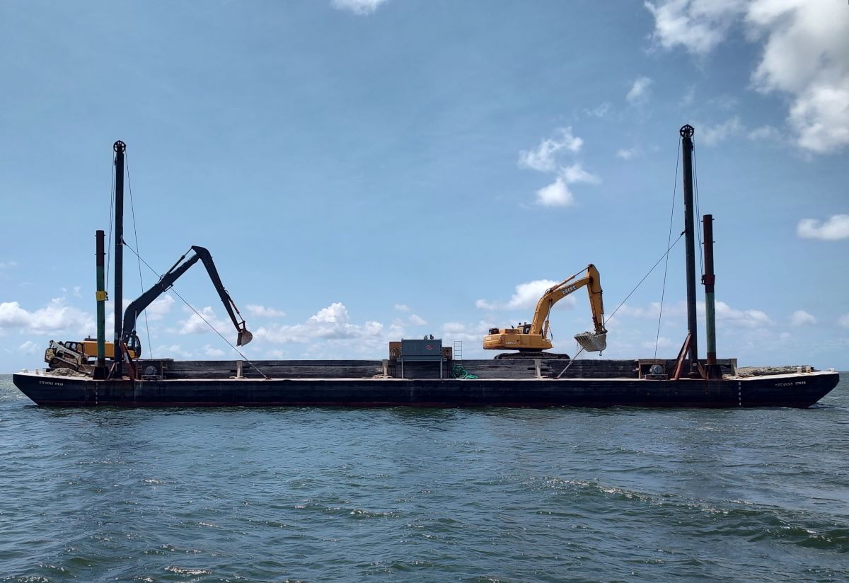 Excavators deploy limestone marl and concrete into the Pamlico Sound Tuesday to build the Cedar Island Oyster Sanctuary. Photo: Jennifer Allen