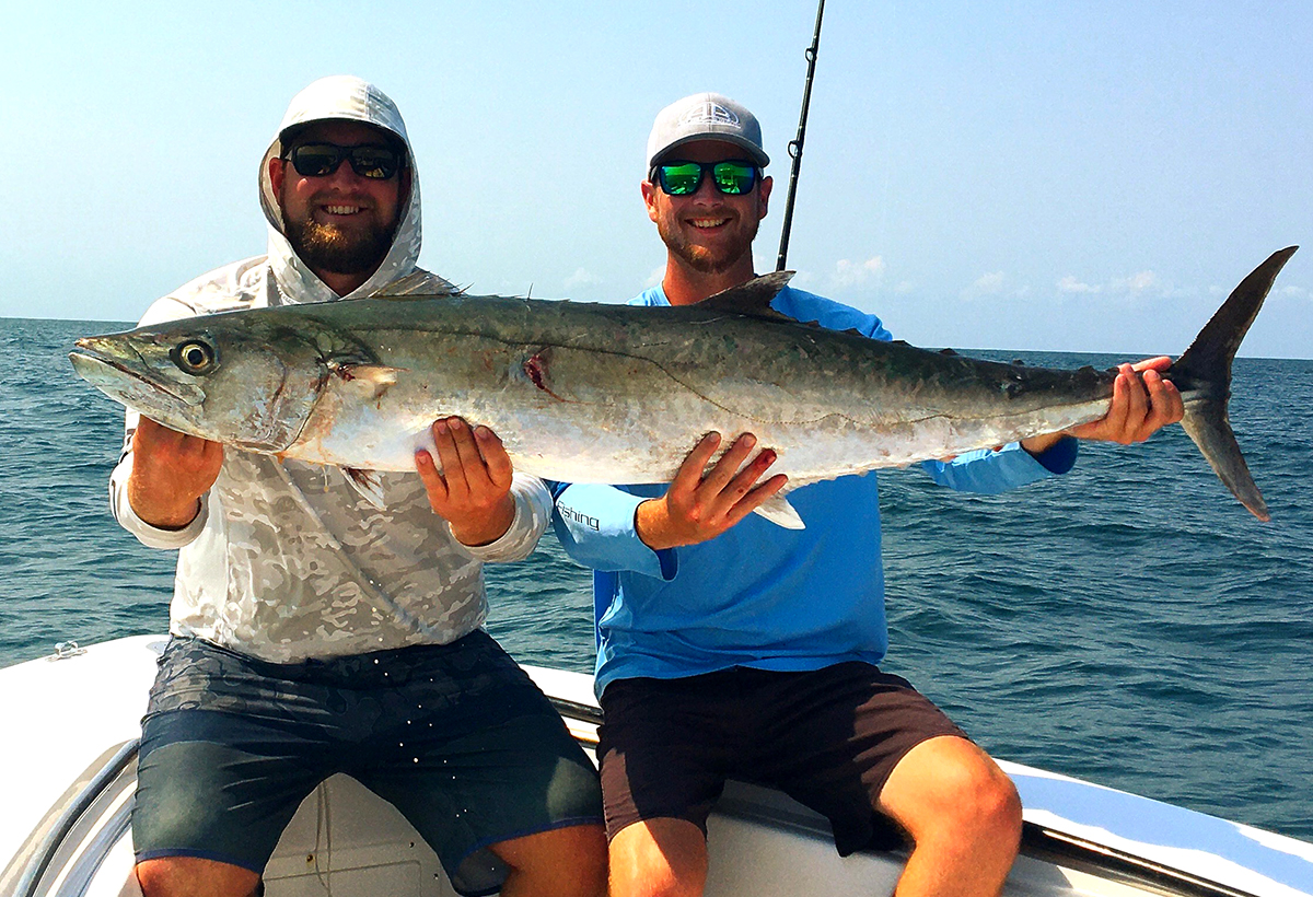 Charter Capt. Will Gillikin of Local Knowledge Charters of Atlantic Beach and his client Andrew Swindell of Morehead City show off a big king. Photo: Courtesy Will Gillikin
