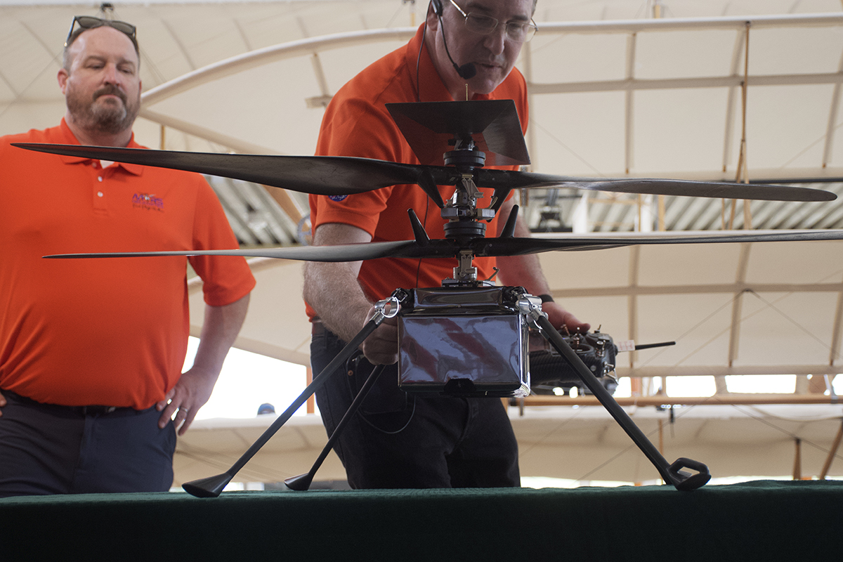 Scott Newbern, left, and Matt Keenum of AeroVironment check the demonstration model of Ingenuity preflight Friday in the Wright Flyer Rotunda. Photo: Kip Tabb