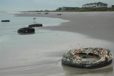 Tires from an artificial reef project that ran from 1974-84 are strewn along Bogue Banks on the morning after Hurricane Earl’s pass off the coast in 2010. Photo courtesy Carteret County News-Times