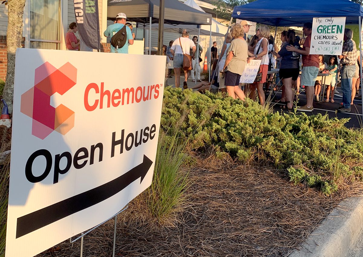Protestors at an open house event Wednesday in Leland hold signs expressing their concerns about Chemours expanding productions at its Fayetteville Works plant. Photo: Trista Talton