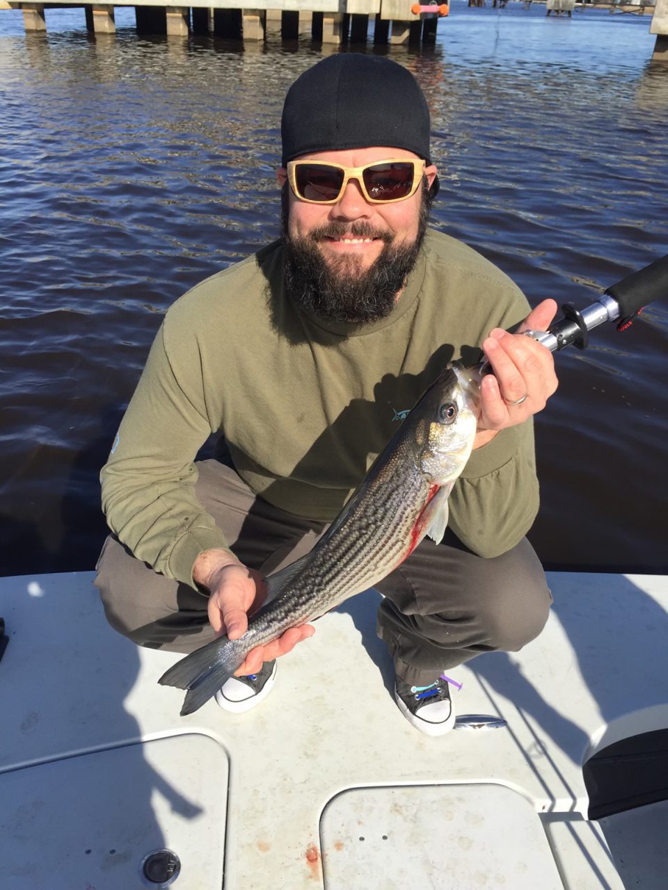 Chris shows off a nice striped bass. Photo courtesy Chris Medlin.