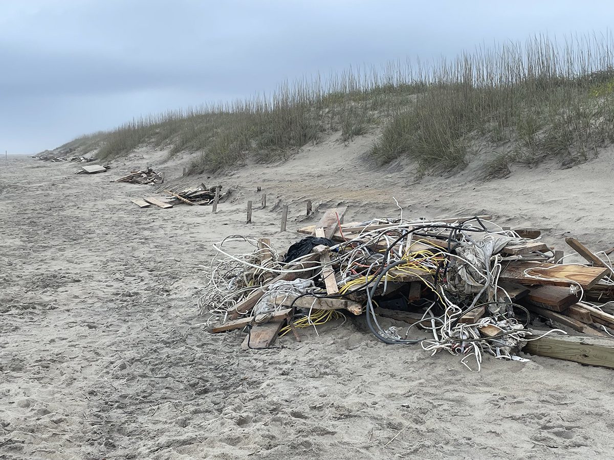 Piles of collected debris associated with collapsed houses in this May 13 Cape Hatteras National Seashore photo.