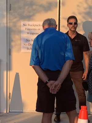 A Chemours security guard stands at an entrance to the Leland Cultural Arts Center as dozens wait to go inside to hear presentations made by Chemours officials. Photo: Trista Talton