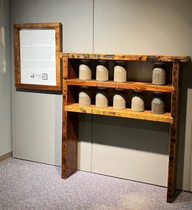 The 1898 soil jars are housed in a wooden display case created by Kids Making It, a non-profit organization on Castle Street. Photo: Cape Fear Museum