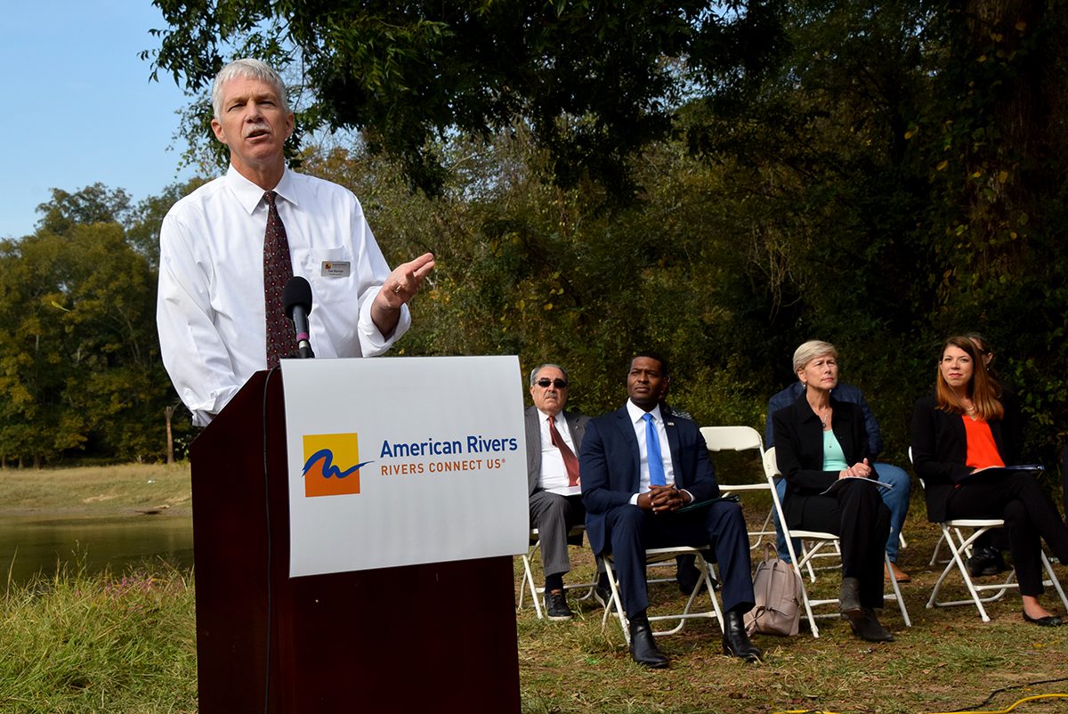 American Rivers President Tom Kiernan speaks Monday during an event at a riverside park in Goldsboro. Also shown are, seated from left, Rep. G.K. Butterfield, EPA Administrator Michael Regan, Rep. Deborah Ross and DEQ Secretary Elizabeth Biser. Also seated are N.C. Rep. John Bell and Sound Rivers Executive Director Heather Deck. Photo: Mark Hibbs