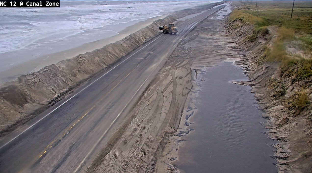 An excavator moves sand in the Canal Zone near the Basnight Bridge at 7:45 a.m. Tuesday. Photo: NCDOT