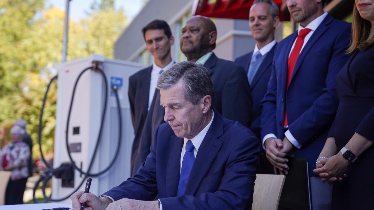 Gov. Roy Cooper signs his executive order expanding the zero-emission vehicle sector in the state in this Oct. 25 photo from the governor's press office.