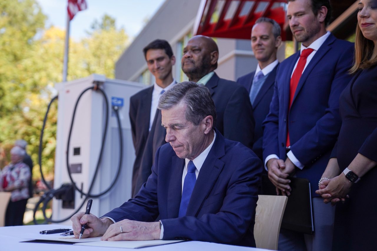 Gov. Roy Cooper signs his executive order expanding the zero-emission vehicle sector in the state in this Oct. 25, 2022, photo from the governor's press office.