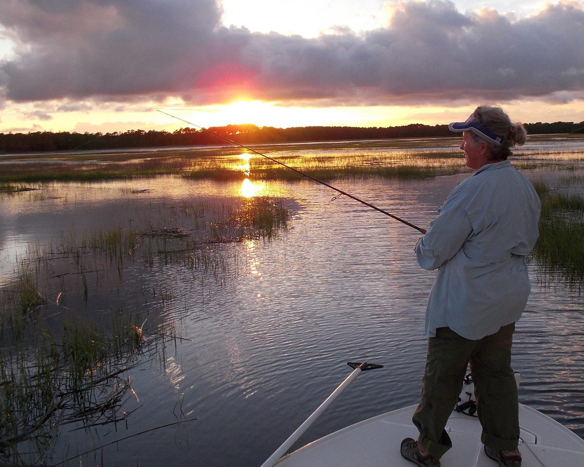 Donna Dilsaver searches for redfish tails on a Spartina grass patch.  Photo courtesy of Jerry Dilsaver