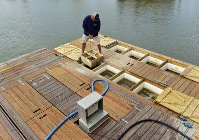 A shellfish grower is shown using a floating upweller system. Photo: NCDEQ