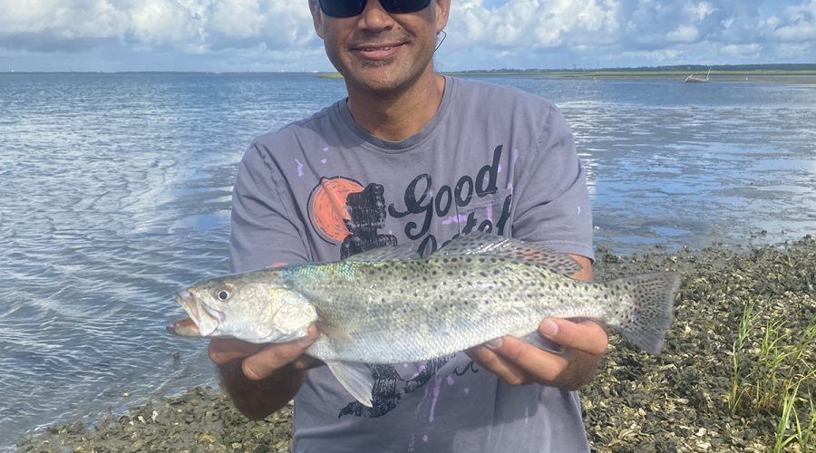 Micheal Howlett, originally from Oahu and now of Newport, shows off a nice trout caught off an oyster bar in Carteret County. Photo: Contributed