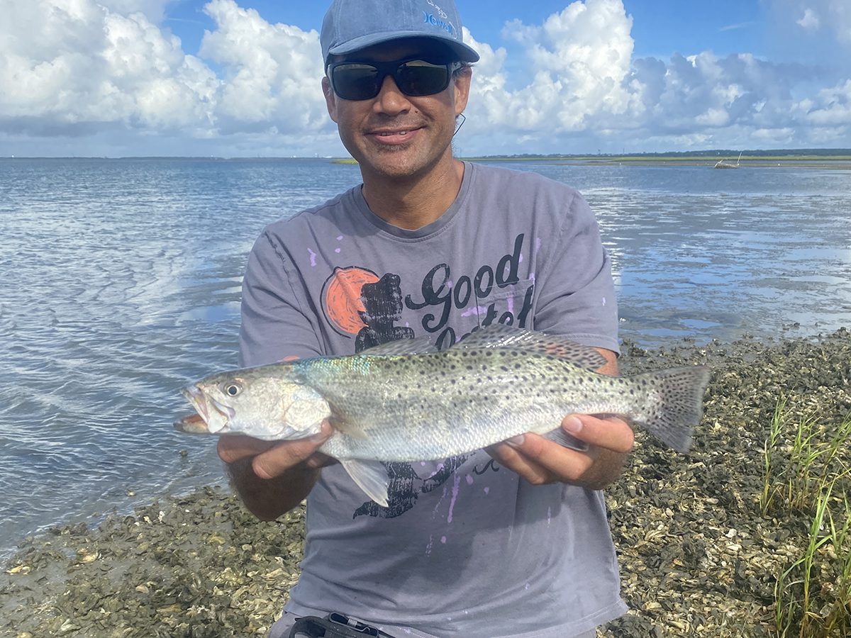 Micheal Howlett, originally from Oahu and now of Newport, shows off a nice trout caught off an oyster bar in Carteret County. Photo: Contributed