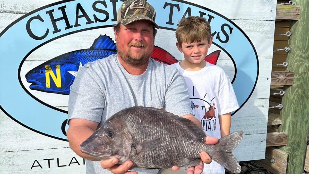 Logan Ennis of Red Oak and his son show the 4-pound, 13.6-ounce fish they caught Jan. 2 near the 14 Buoy off Morehead City. Photo: DMF