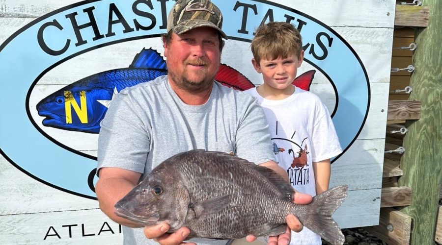 Logan Ennis of Red Oak and his son show the 4-pound, 13.6-ounce fish they caught Jan. 2 near the 14 Buoy off Morehead City. Photo: DMF