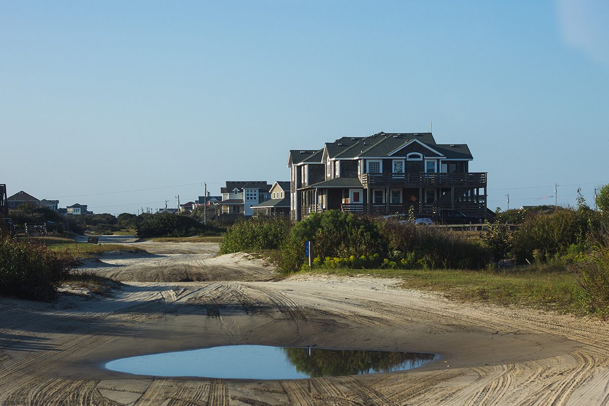 Water pools in ditches along Carova’s beach roads where tire tracks dig into the sand. Standing water like this can prove toxic for the herd of wild horses that has roamed here for centuries. Photo: Josee Molavi