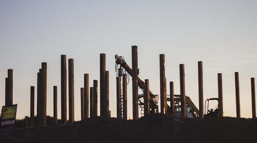 Structural pillars rise up out of the sand at a new construction site in Carova. Photo: Josee Molavi