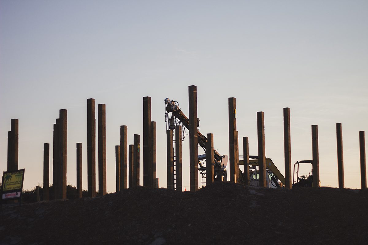 Structural pillars rise up out of the sand at a new construction site in Carova. Photo: Josee Molavi