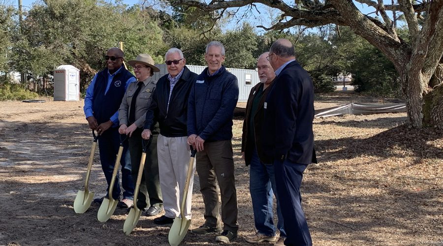 State and local officials break ground Friday at the historic teachers’ building at Hammocks Beach State Park. The building, which hosted Black educators during segregation, is being restored and transformed into a community space. Photo: Trista Talton