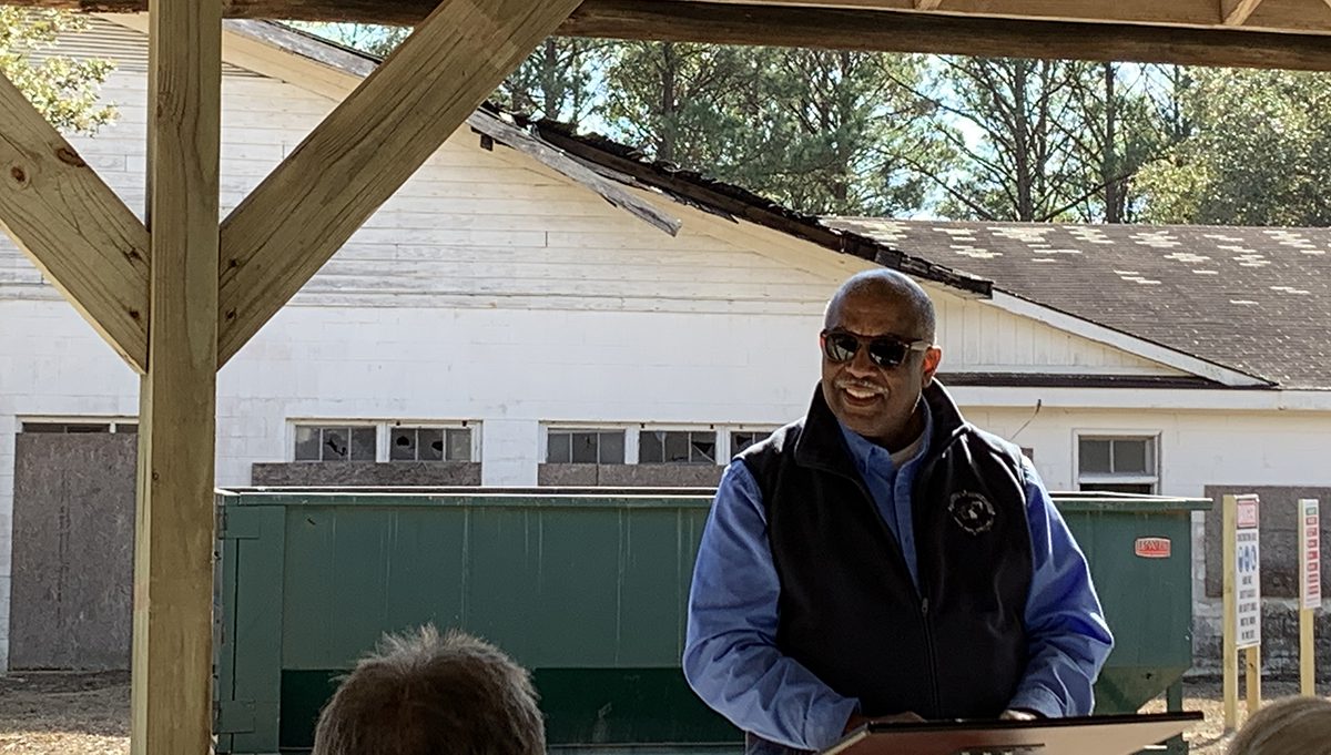 N.C. Division of Parks and Recreation Director Dwayne Patterson speaks to a small audience Friday in front of the teachers’ building at Hammocks Beach State Park. Photo: Trista Talton
