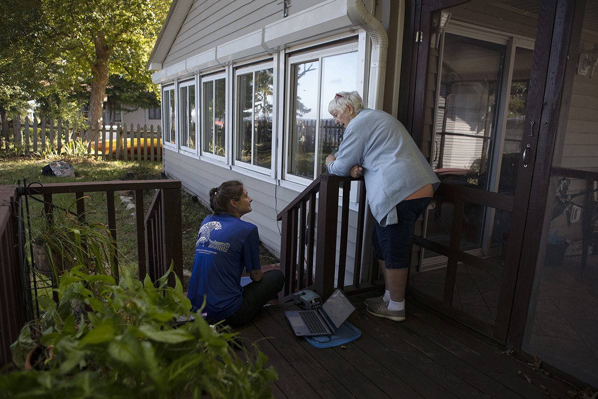 Plaas chats with CEEG member Cathy Woody while downloading sensor data at her house. The team plans to deploy up to 30 sensors along the Chowan River. This project is being conducted for two years, but the sensors last far longer— providing valuable public data even after the study wraps. Photo: Megan May