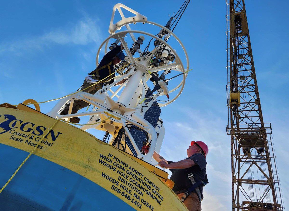 Jim Ryder and Kris Newhall complete assembly of At-Sea Test 3 surface buoy to be deployed at new Pioneer Mid-Atlantic Bight location this month. The test moorings will confirm the design of the systems to be implemented within the new array in Spring 2024. Photo: Jared Schwartz WHO