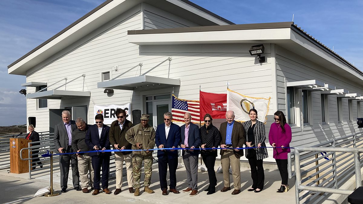 Katherine Brodie, fourth from right in black coat, the senior technical manager at the Corps’ Field Research Facility in Duck, takes part with other officials in a ribbon cutting Jan. 19 for the new annex at the Duck Pier. Photo: Catherine Kozak