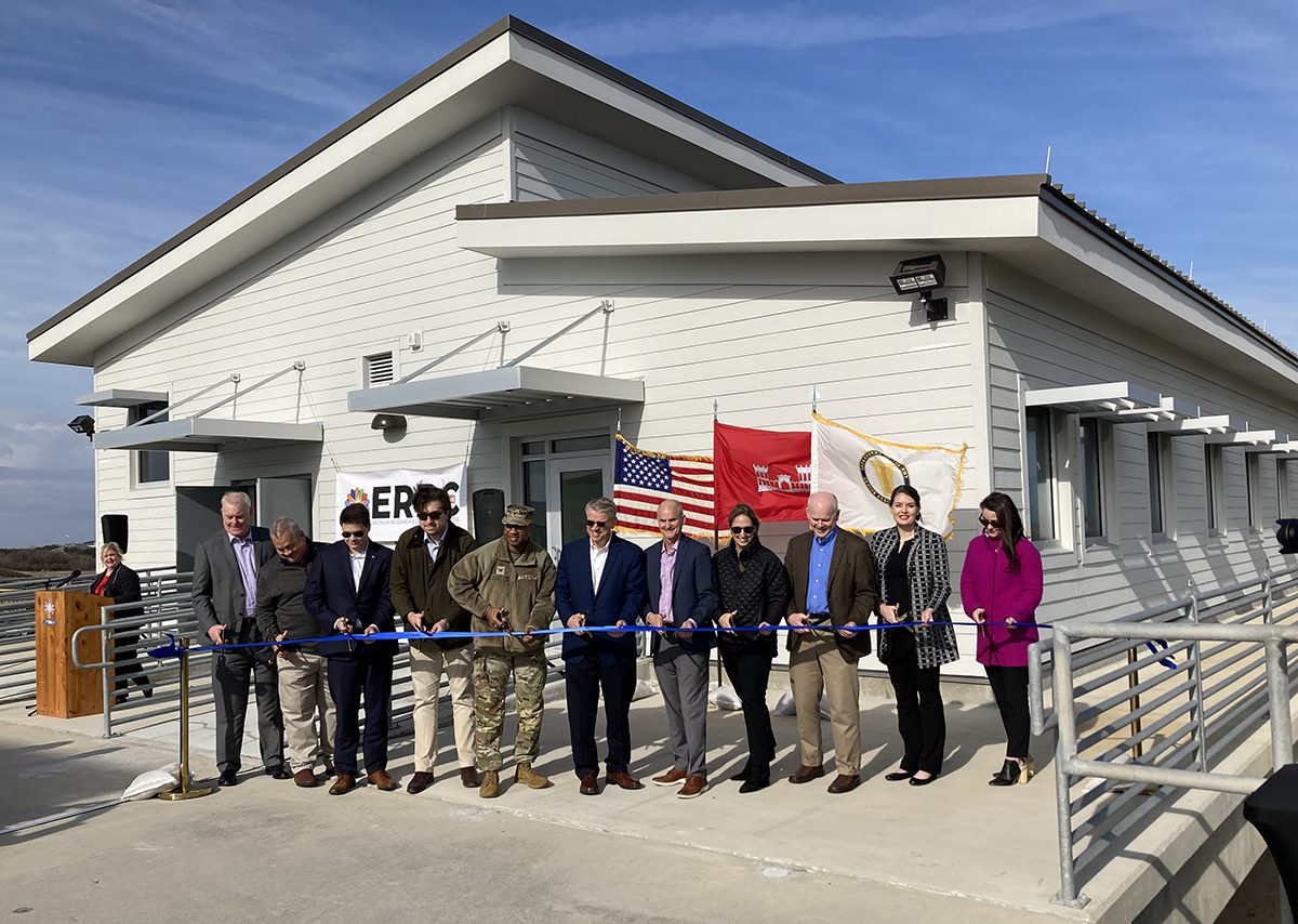 Katherine Brodie, fourth from right in black coat, the senior technical manager at the Corps’ Field Research Facility in Duck, takes part with other officials in a ribbon cutting Jan. 19 for the new annex at the Duck Pier. Photo: Catherine Kozak