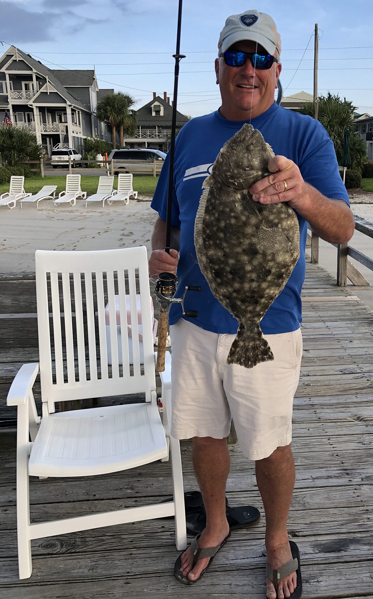 Paul Gilbert shows off a nice flounder caught from the dock. Photo: Contributed