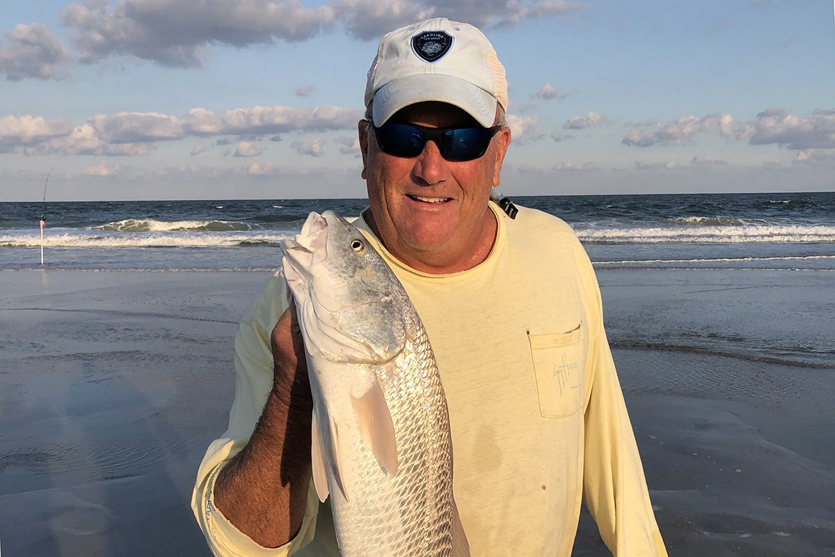 Coach Paul Gilbert scores in the surf. Photo: Contributed