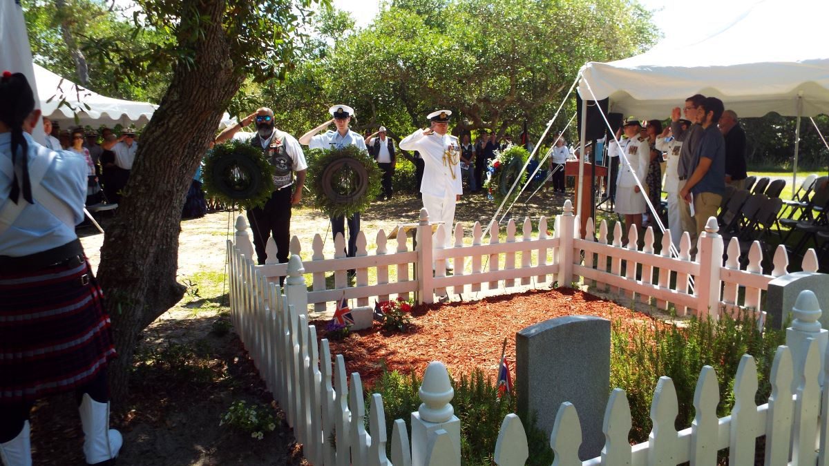 Representatives of the Royal Canadian Legion, United States Coast Guard and the British Royal Navy salute following the laying of the wreaths at the 2019 British War Graves Ceremony held at the British Cemetery in Buxton. The public ceremony returns this year after a three-year hiatus. Photo: NC Maritime Museums