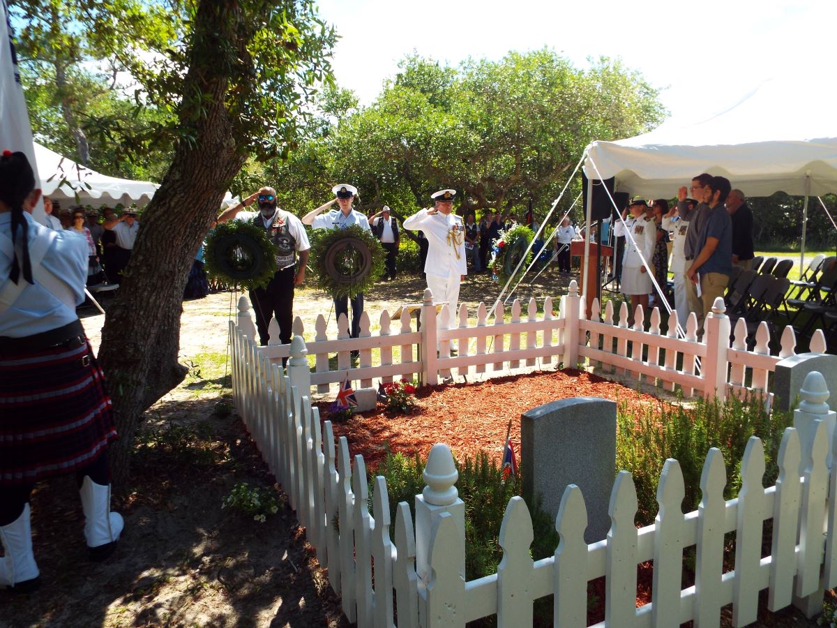 Representatives of the Royal Canadian Legion, United States Coast Guard and the British Royal Navy salute following the laying of the wreaths at the 2019 British War Graves Ceremony held at the British Cemetery in Buxton. The public ceremony returns this year after a three-year hiatus. Photo: NC Maritime Museums