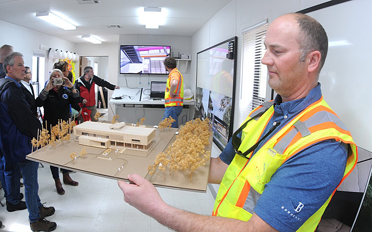 Ben Warren of Bordeaux Construction shows off a 3D rendering of the new Fort Fisher State Historic Site visitor center during a hard hat tour of the facility Friday. The new visitor center that is currently under construction will be roughly three times the size of the existing structure. Photo: Mark Courtney.