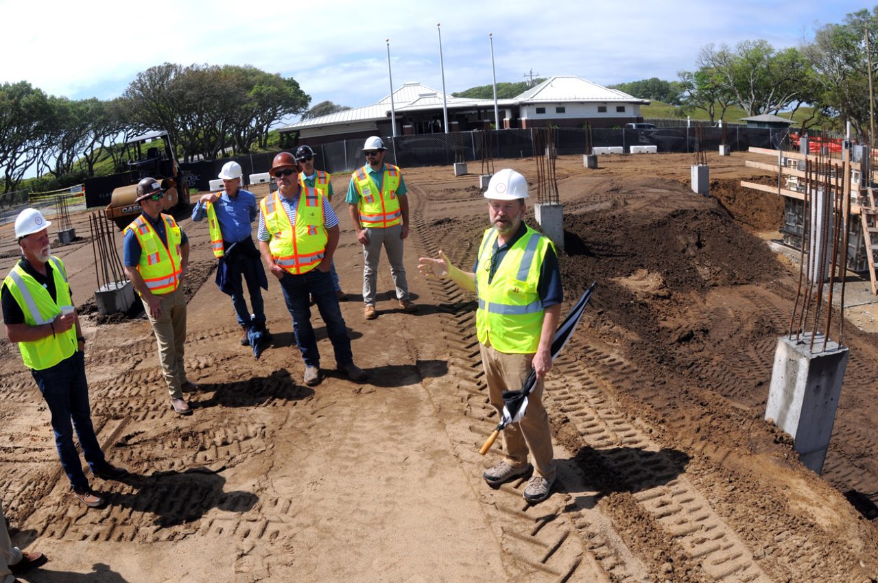 Jim Steele, manager, Fort Fisher State Historic Site, talks about the site's visitor center currently under construction that will be roughly three times the size of the existing structure shown in the background. The concrete pilings shown near the group on a hard-hat tour Friday are 50 feet deep. Photo: Mark Courtney