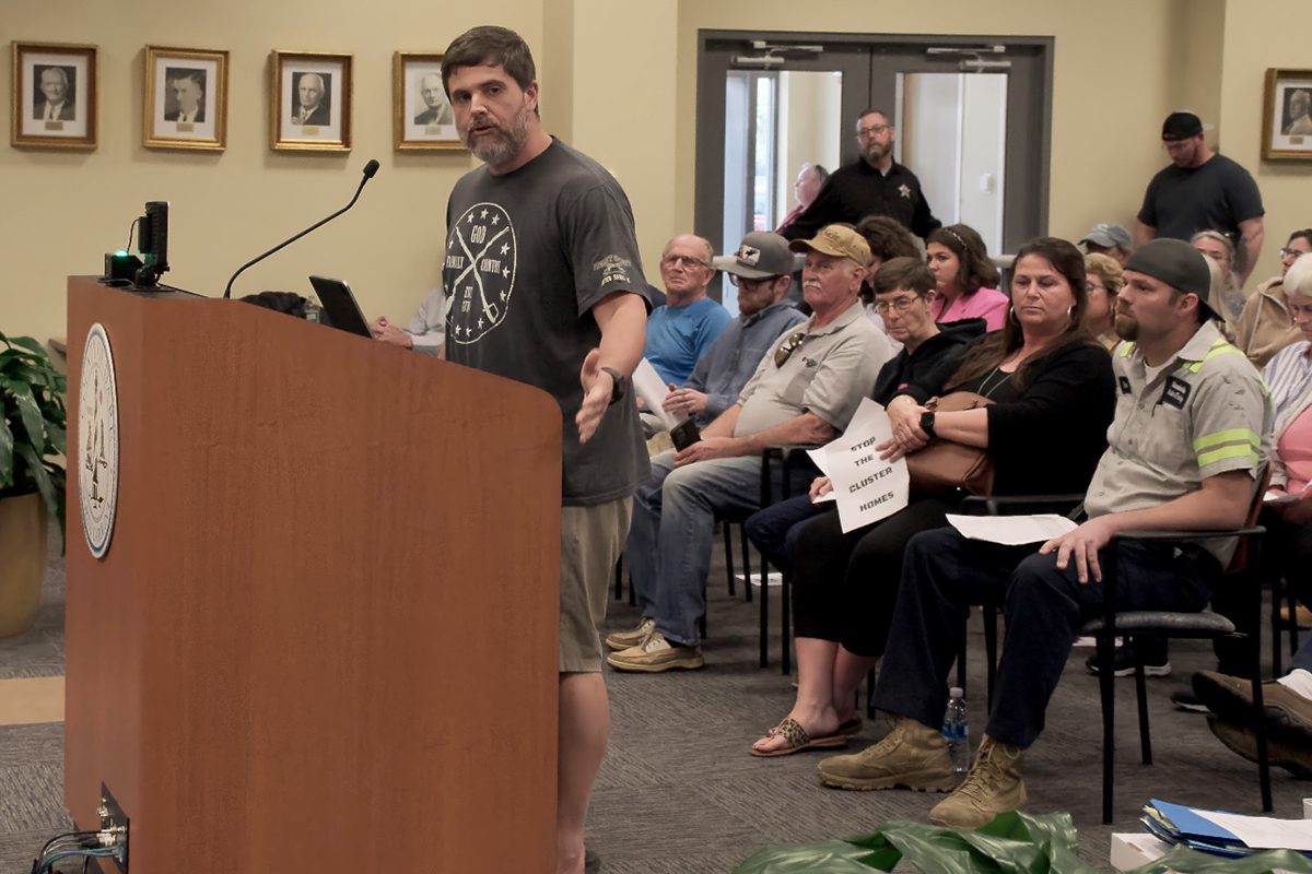 Justin Bateman addresses the cluster home project developer, Brad Alexander of Aria Construction and Development during the Dare County Board of Commissioners meeting Monday. Photo: Kip Tabb