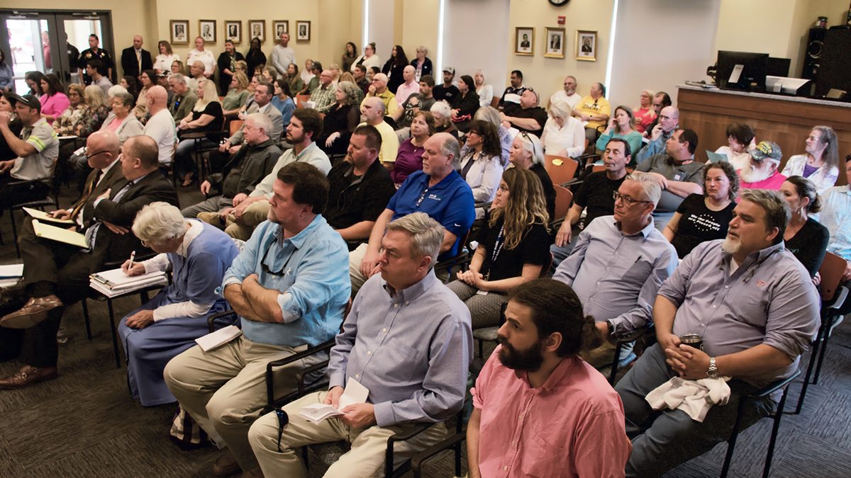 A large portion of the more than 100 people who attended the Dare County Board of Commissioners meeting Monday were opposed to a proposed 60-home cluster development in Wanchese. Photo: Kip Tabb