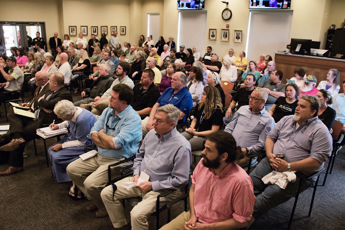 A large portion of the more than 100 people who attended the Dare County Board of Commissioners meeting Monday were opposed to a proposed 60-home cluster development in Wanchese. Photo: Kip Tabb