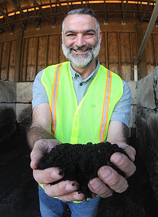 Joe Suleyman, director, New Hanover County Department of Environmental Management, shows off a fresh batch of compost that was converted food waste. Photo: Mark Courtney