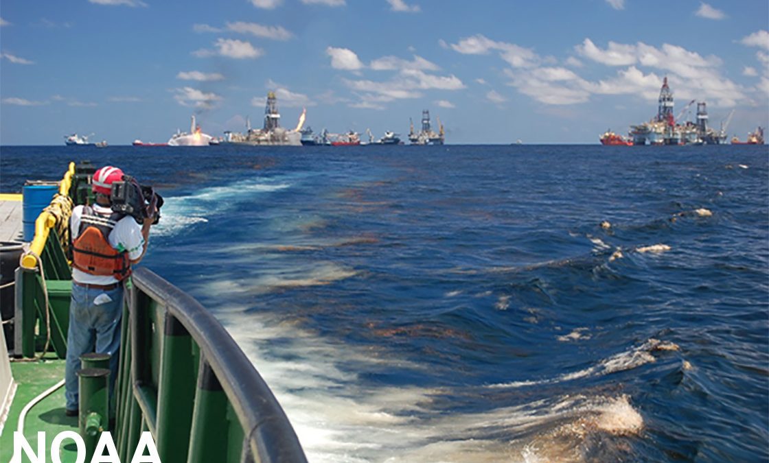 National Geographic videographer Bob Perrin films an oil slick at the Deepwater Horizon site. Photo: NOAA