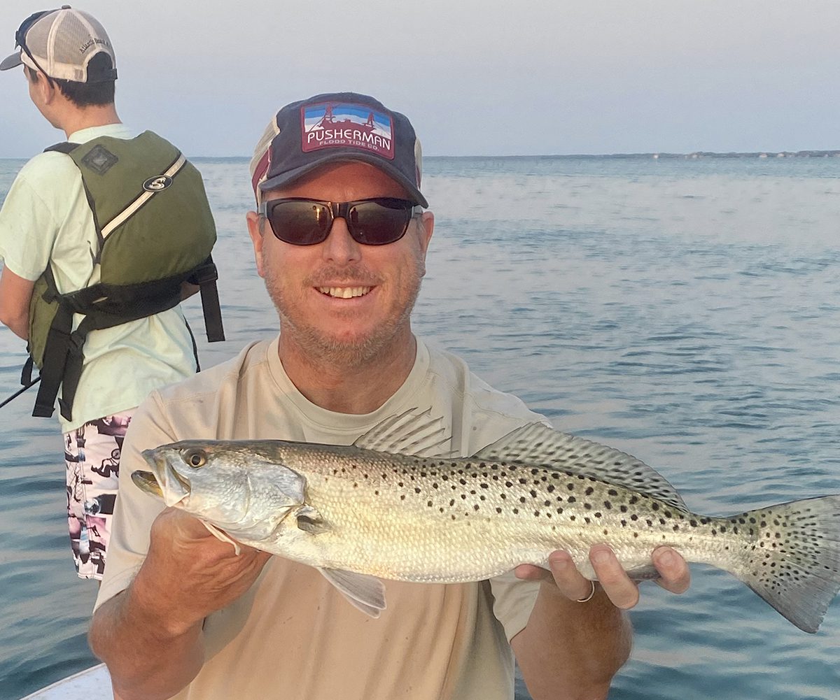 Chris Ellis shows off a big trout caught on a topwater plug. Photo: Gordon Churchill