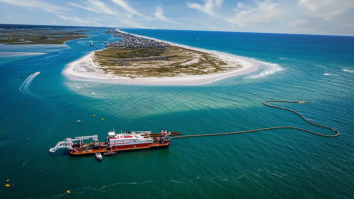 A dredge is shown at work in this aerial view of the south end of Topsail Beach, looking north from New Topsail Inlet. Photo: Topsail Beach