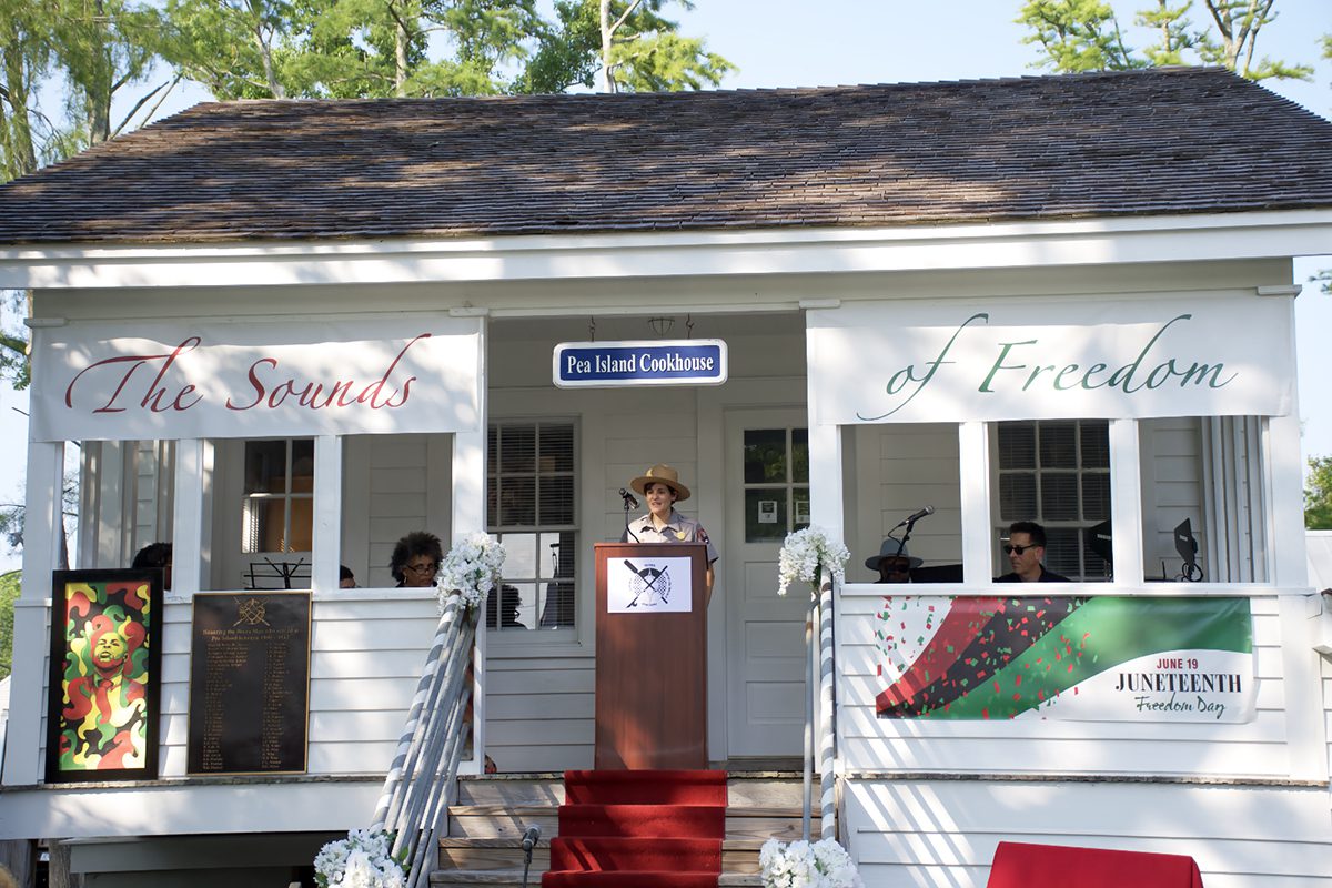National Park Service Ranger Isabel Gonzalez describes the new Freedmen's Trail at Fort Raleigh National Historic Site Saturday during a Juneteenth celebration at the Pea Island Cookhouse Museum. Photo: Kip Tabb