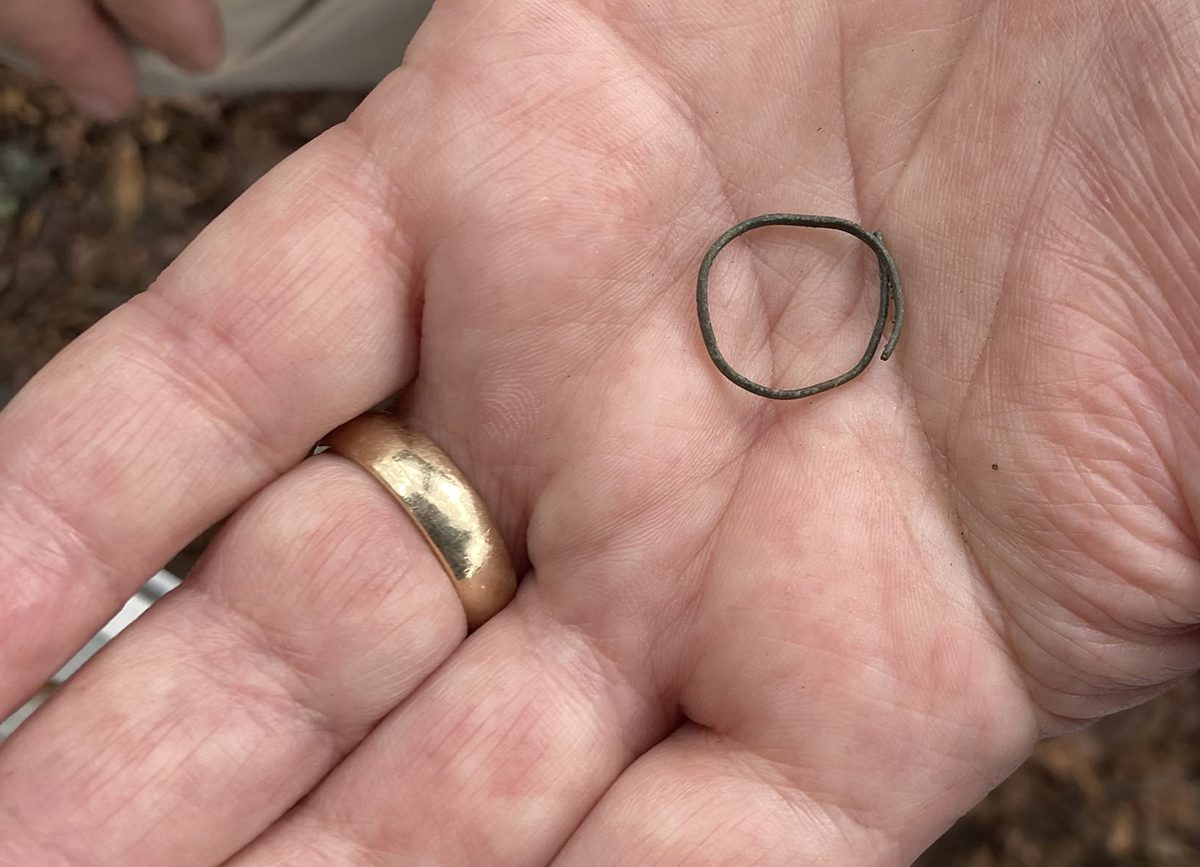 Archaeologist Eric Klingelhofer holds a copper strand discovered during the dig. Photo: Catherine Kozak