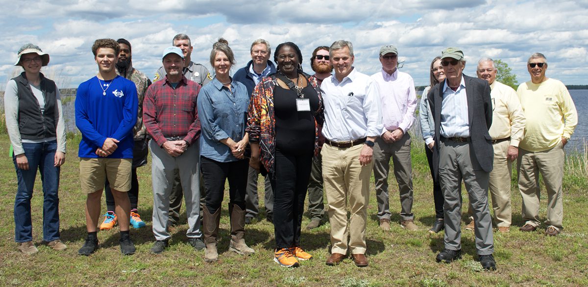 Bertie County Hive House Virtual Learning Center Executive Director Vivian Saunders and Attorney General Josh Stein, both at center, pose with others at the May 4 event at the Bertie County Tall Glass of Water site on the Chowan River. Photo: Kip Tabb