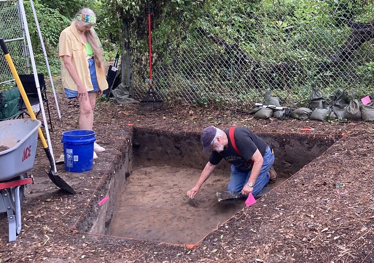 Volunteers Mona Currie, left, and Jack Currie work at one of three pits at site. Photo: Catherine Kozak