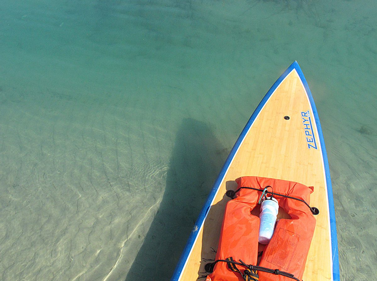 Mark Courtney’s SUP travels through crystal clear blue water on an incoming tide behind Figure Eight Island in northern New Hanover County near Wilmington. Photo: Mark Courtney