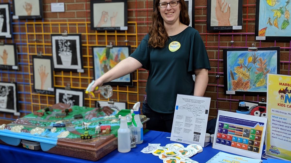 Sediment Education Engineer Rebecca Coppa demonstrates how erosion can happen using the 3-D Enviroscape tool during a past event at Marbles Kids Museum in Raleigh. Photo: NCDEQ