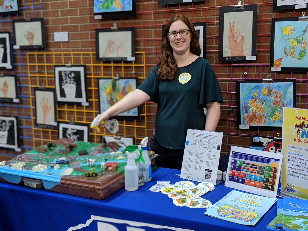 Sediment Education Engineer Rebecca Coppa demonstrates how erosion can happen using the 3-D Enviroscape tool during a past event at Marbles Kids Museum in Raleigh. Photo: NCDEQ
