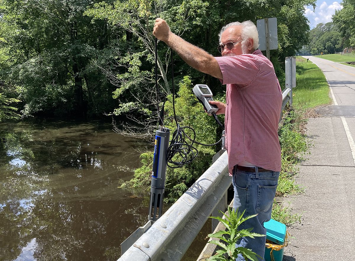 Steve Karl, Colleen Karl's husband and a member of the Chowan Edenton Environmental Group board, collects samples earlier this week from a tributary flowing into Potecasi Creek near Conway. Photo: Colleen Karl