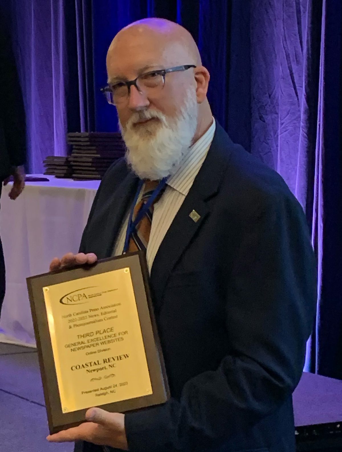Coastal Review Editor Mark Hibbs accepts the North Carolina Press Association's third-place award for General Excellence For Websites Thursday in Raleigh.  